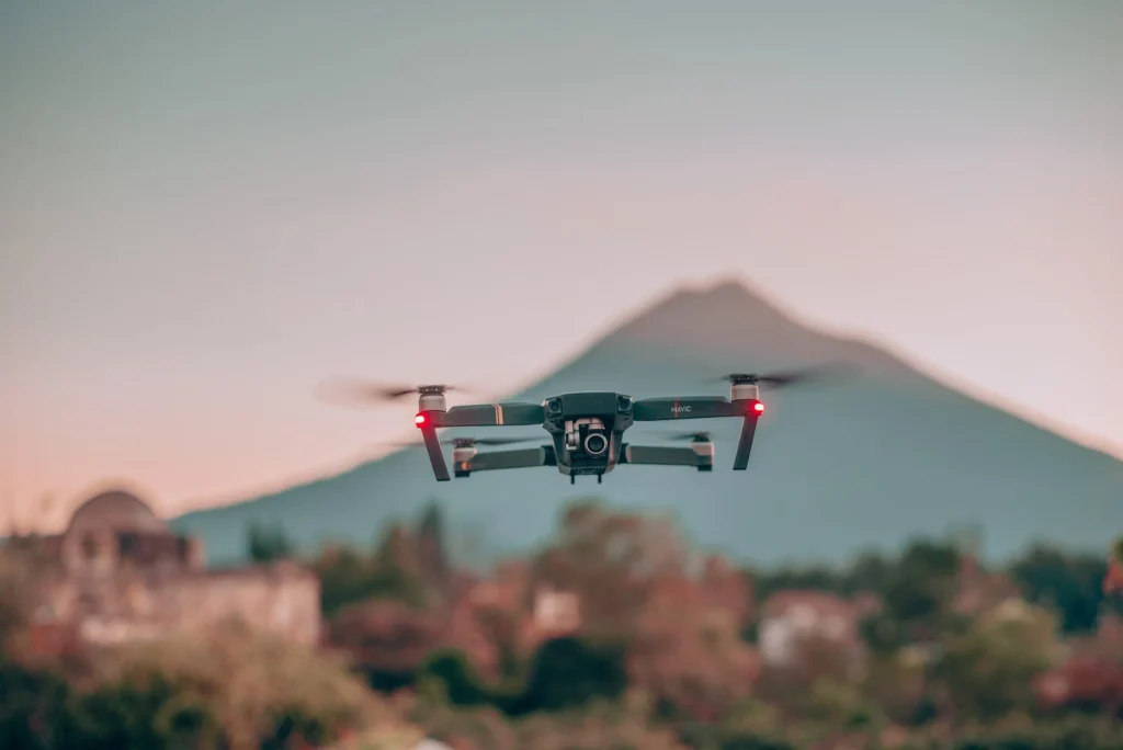 DJI Mavic Pro hovering at dusk with a volcano silhouetted in the background